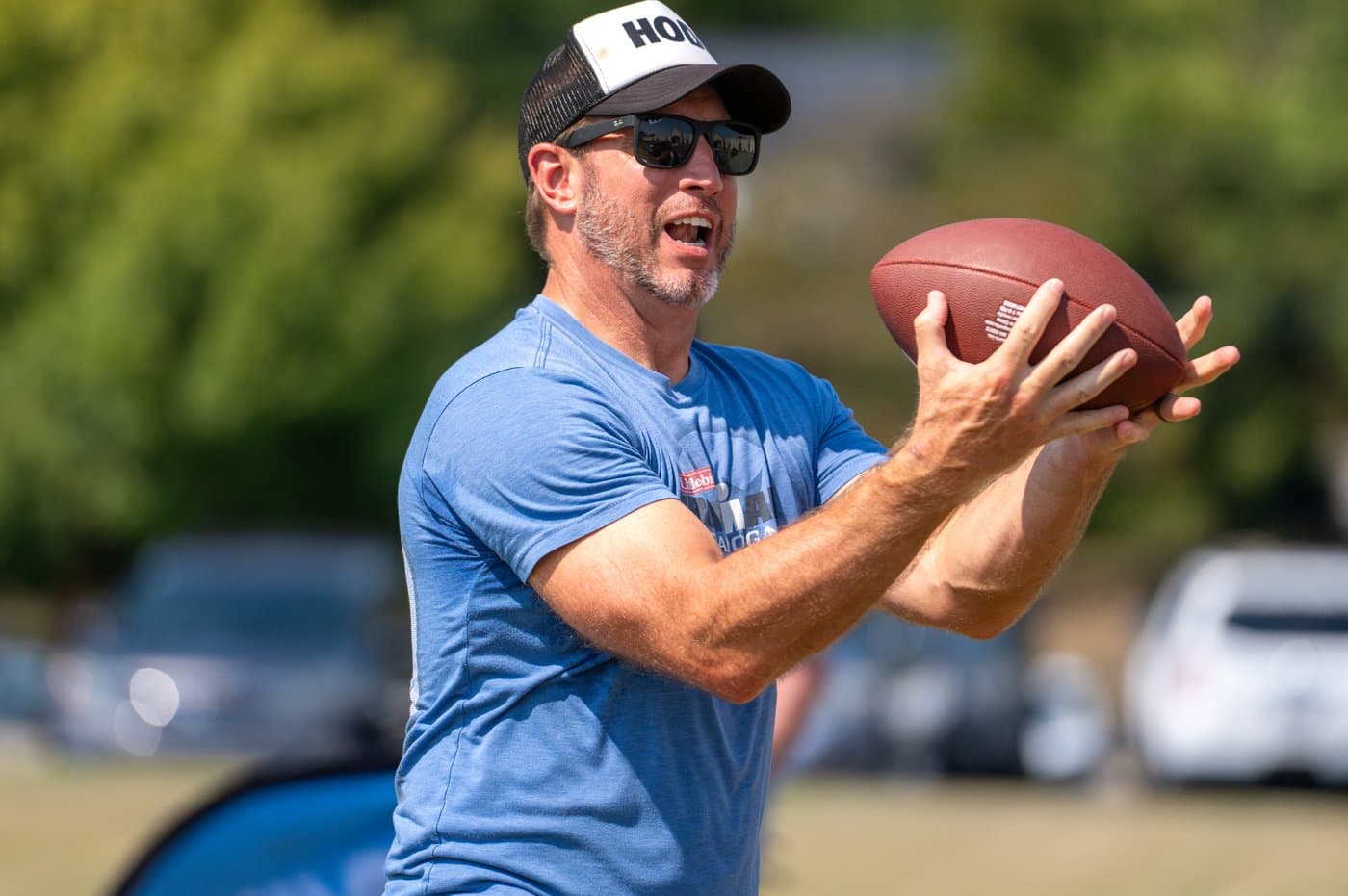 A man catching a football at a Brainerd Baptist men's ministry event