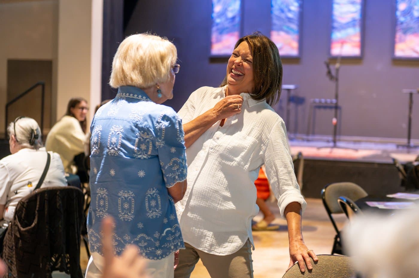 Women of different generations sharing a laugh at a Brainerd Baptist women's ministry event