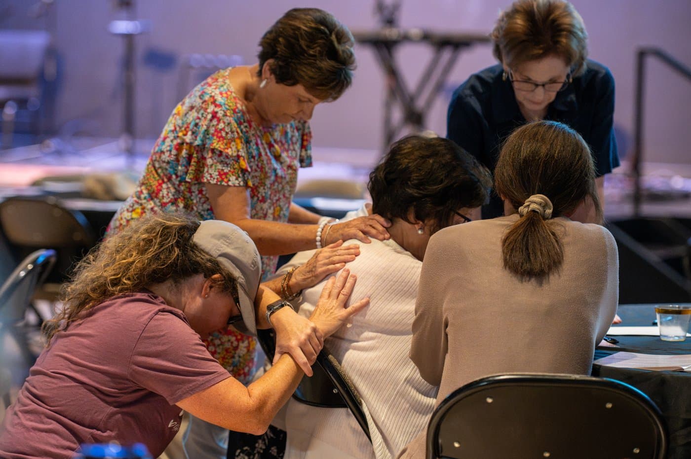 Women praying together at a Brainerd Baptist women's ministry event